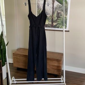 Reformation linen jumpsuit with length adjustable button straps and tie belt